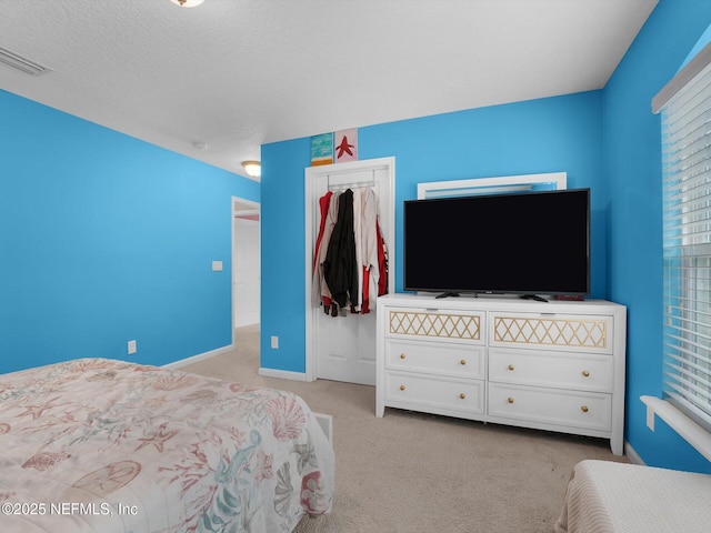 carpeted bedroom featuring a closet and a textured ceiling