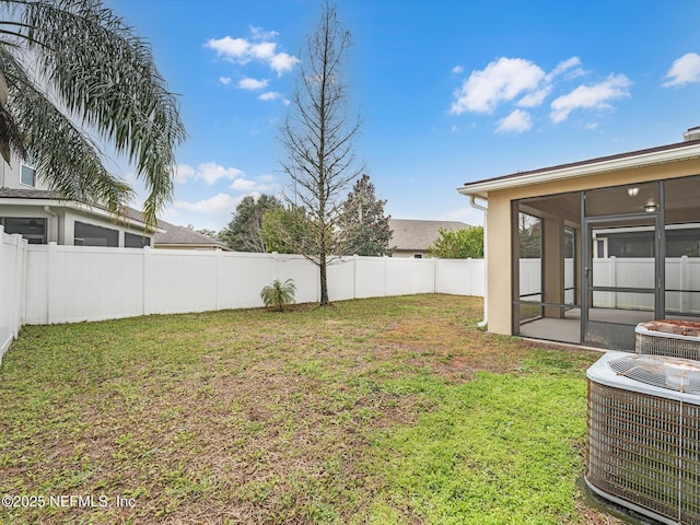 view of yard with cooling unit and a sunroom