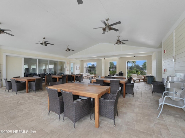 dining room with plenty of natural light and vaulted ceiling