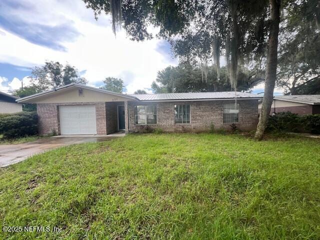 ranch-style home with a garage and a front lawn