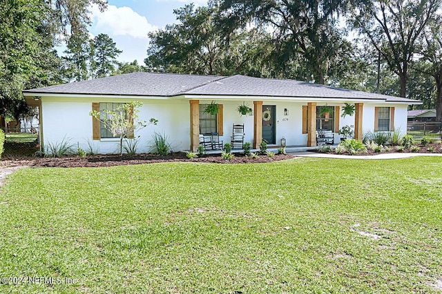 single story home featuring covered porch and a front lawn