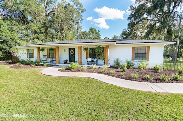 ranch-style home with a front yard and a porch