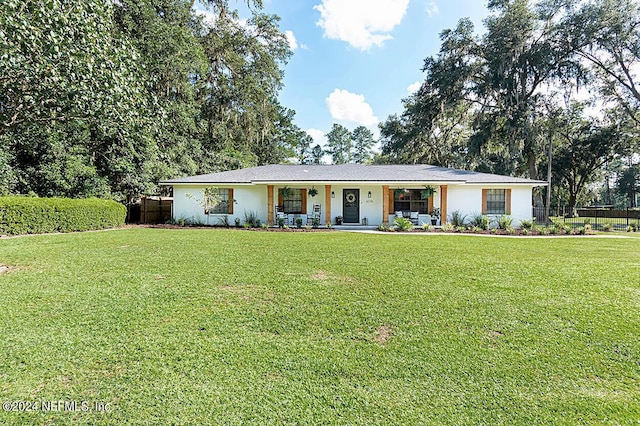 ranch-style home with a front yard and covered porch