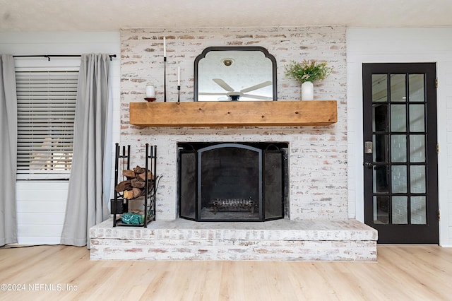 interior details featuring a textured ceiling, a fireplace, and wood-type flooring