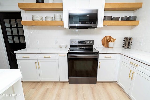 kitchen with tasteful backsplash, light stone counters, and stainless steel appliances