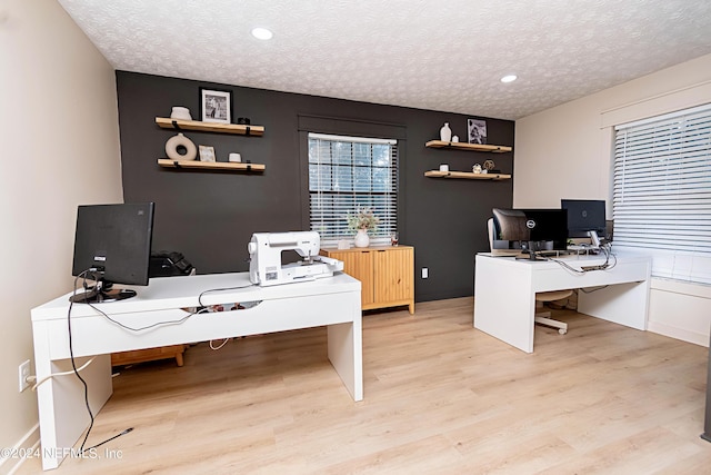 office featuring a textured ceiling and light hardwood / wood-style flooring