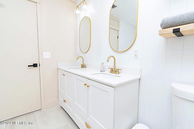 bathroom featuring toilet, vanity, and tile patterned floors