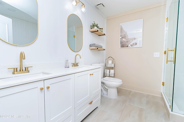 bathroom with tile patterned floors, an enclosed shower, vanity, and toilet