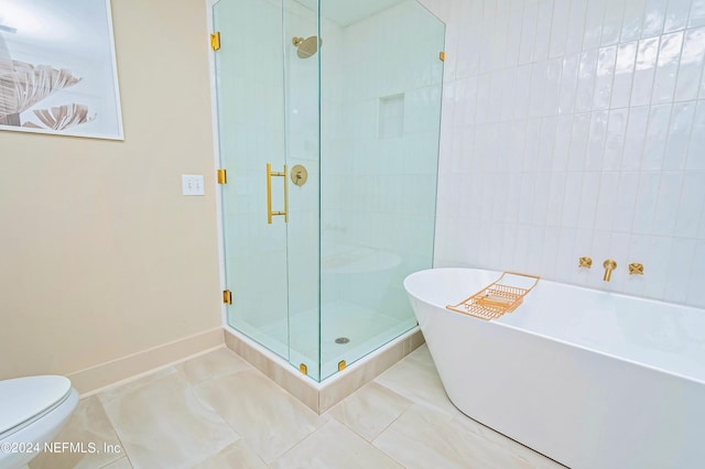 bathroom featuring plus walk in shower, toilet, and tile patterned flooring