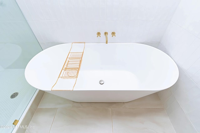 bathroom with tile patterned flooring and tile walls