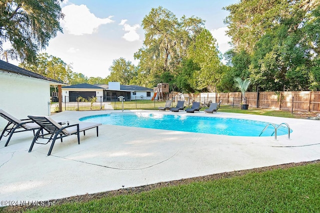 view of swimming pool with a patio area