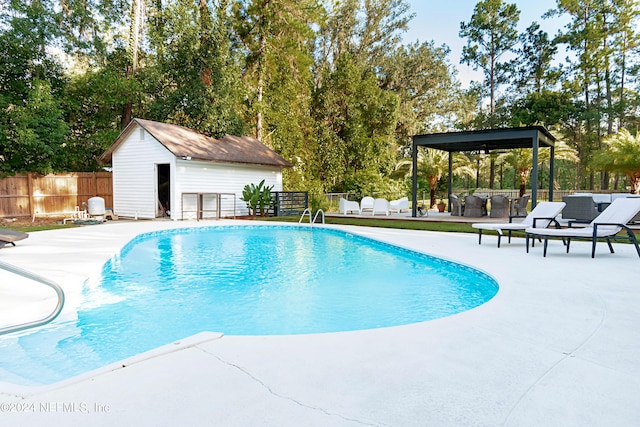 view of pool with an outbuilding and a patio