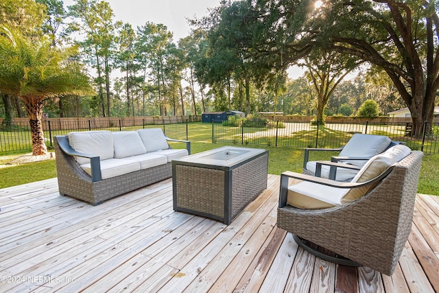 wooden terrace with an outdoor hangout area and a lawn