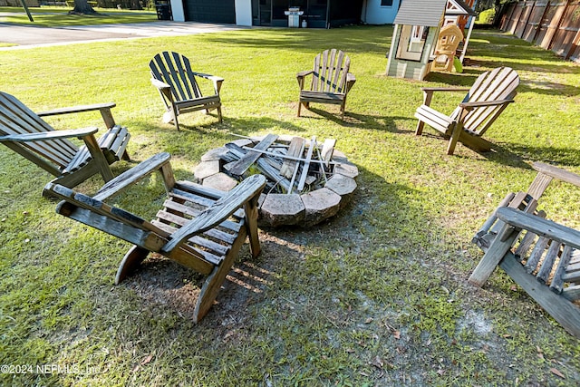 view of home's community with a lawn, an outdoor fire pit, and a playground