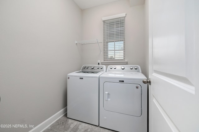 laundry area with light tile patterned flooring and separate washer and dryer