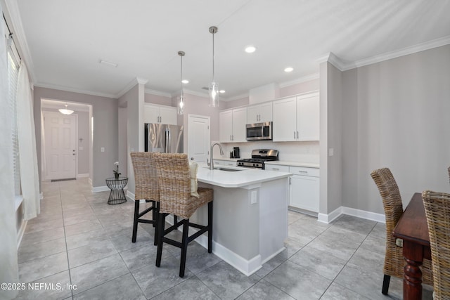 kitchen with sink, stainless steel appliances, white cabinets, and a center island with sink