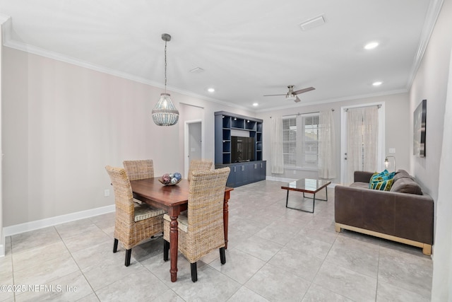 tiled dining space featuring ornamental molding and ceiling fan