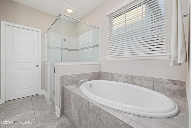 bathroom with tile patterned floors and shower with separate bathtub