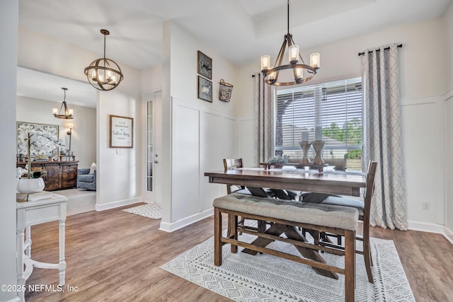 dining area featuring hardwood / wood-style flooring and a chandelier