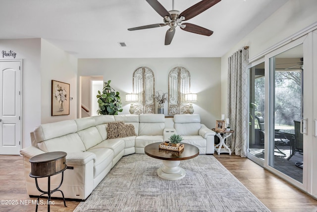 living room with ceiling fan and wood-type flooring