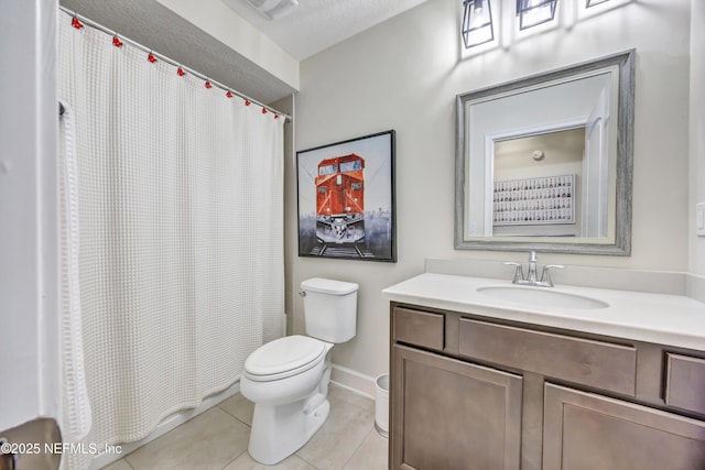 bathroom with tile patterned floors, vanity, and toilet