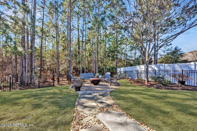 view of yard with a fire pit