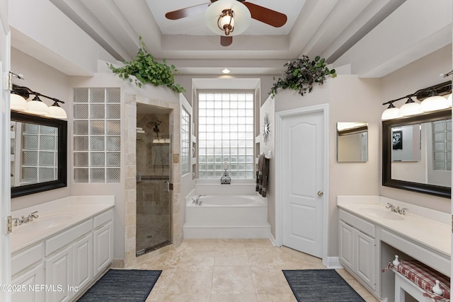 bathroom with independent shower and bath, a tray ceiling, and vanity