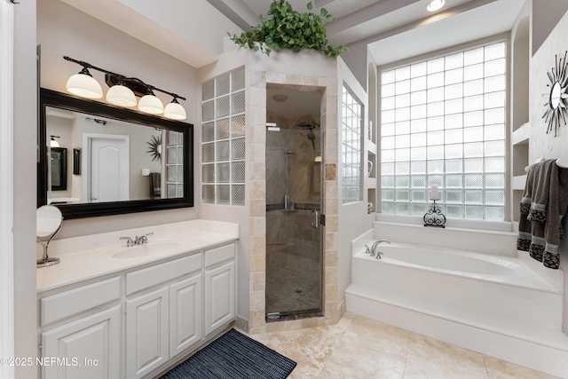 bathroom featuring vanity, independent shower and bath, and a healthy amount of sunlight