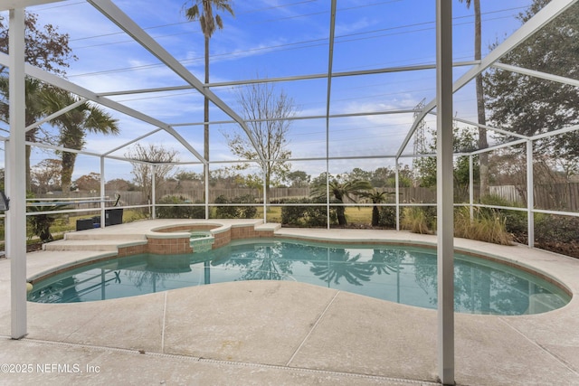 view of swimming pool with a patio, glass enclosure, and an in ground hot tub