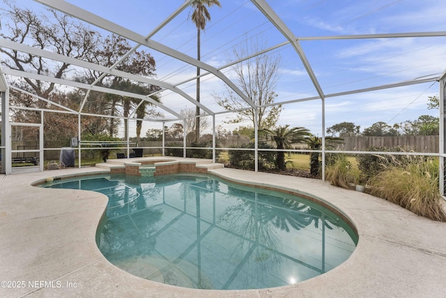 view of swimming pool with glass enclosure, an in ground hot tub, and a patio