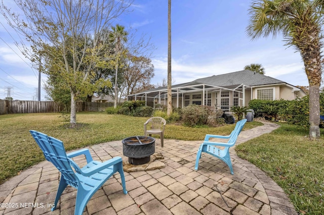 view of patio with glass enclosure and a fire pit