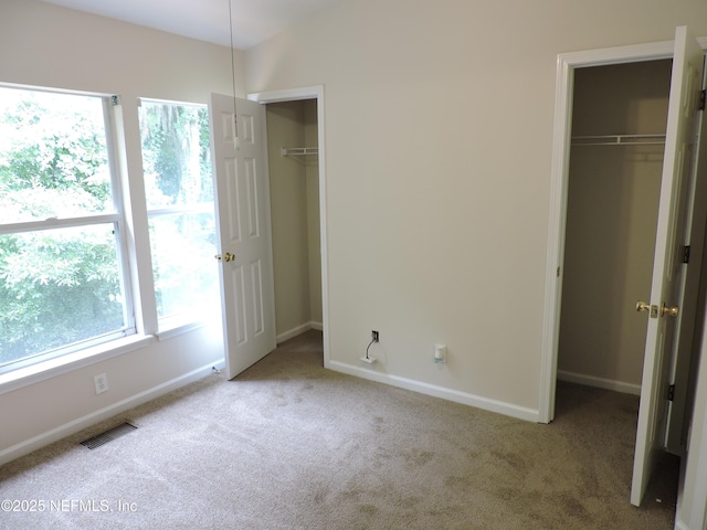 unfurnished bedroom with light colored carpet