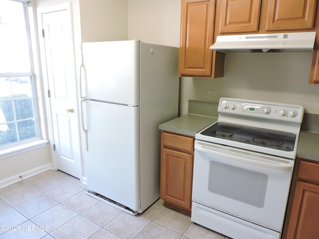 kitchen featuring light tile patterned floors and white appliances