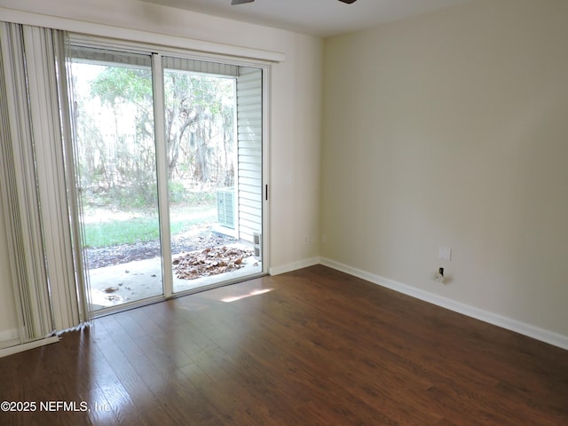 spare room featuring ceiling fan and dark hardwood / wood-style floors