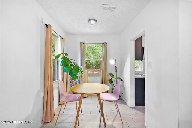 dining space with a textured ceiling