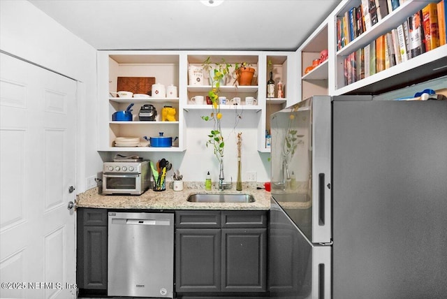 kitchen with stainless steel appliances and light stone countertops