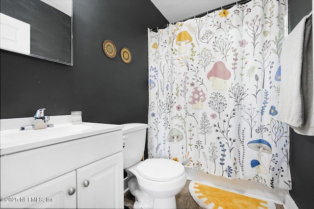 bathroom featuring vanity, toilet, and a shower with shower curtain