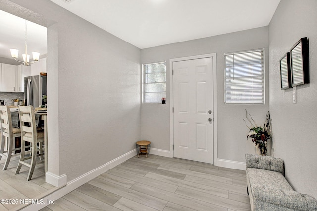 foyer featuring a notable chandelier and light hardwood / wood-style floors