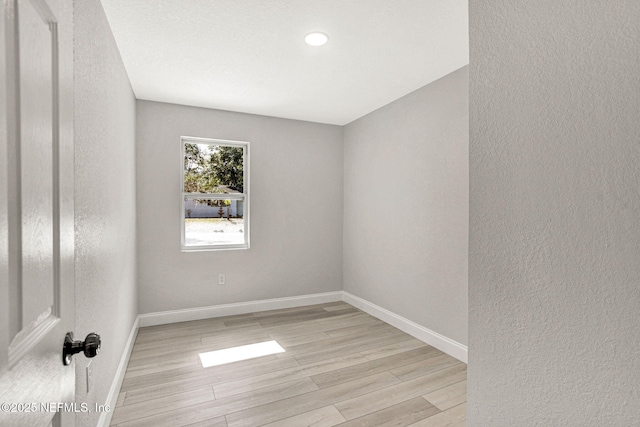 spare room with light hardwood / wood-style flooring