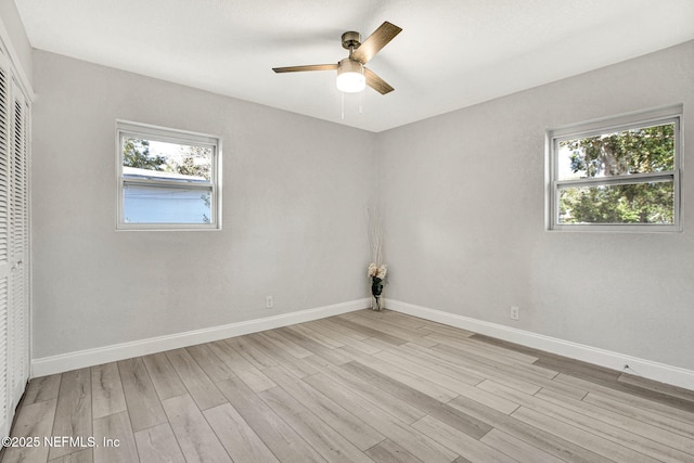 spare room with light hardwood / wood-style flooring and ceiling fan