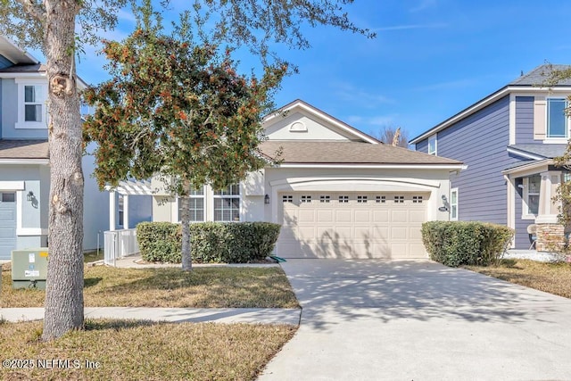 view of front of property with a garage and a front yard