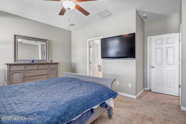 carpeted bedroom with ceiling fan and a textured ceiling