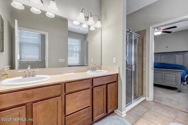 bathroom with an enclosed shower, vanity, tile patterned floors, and ceiling fan