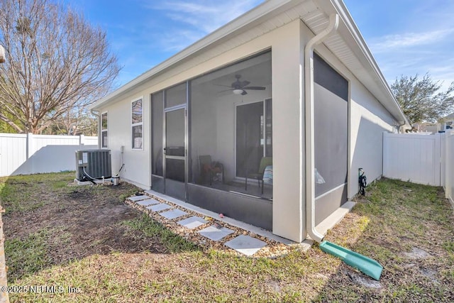 exterior space featuring a sunroom, ceiling fan, and central air condition unit