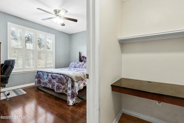 bedroom with ceiling fan and dark wood-type flooring