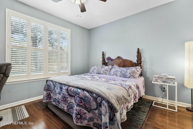 bedroom with ceiling fan, dark hardwood / wood-style floors, and multiple windows