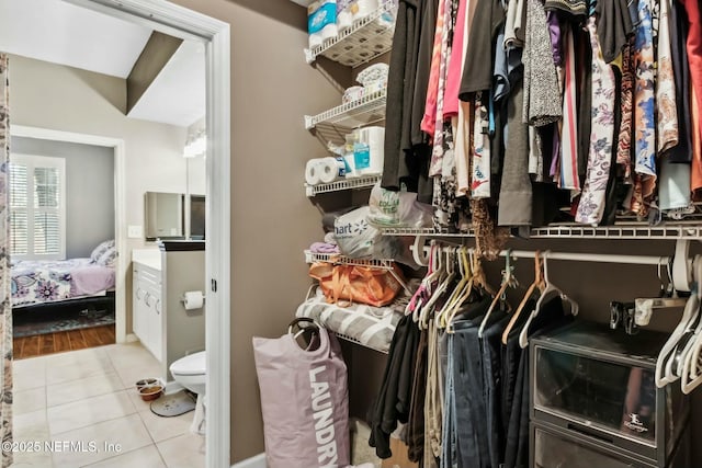 walk in closet featuring light tile patterned flooring