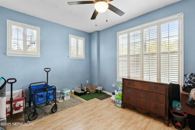 misc room with ceiling fan and light hardwood / wood-style flooring