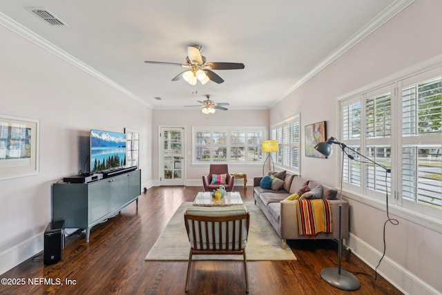 living room with plenty of natural light, dark wood-type flooring, and ornamental molding