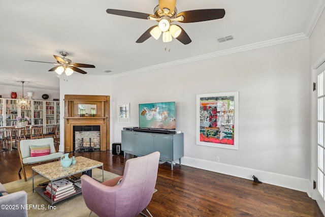 living room featuring crown molding, ceiling fan with notable chandelier, and dark hardwood / wood-style flooring